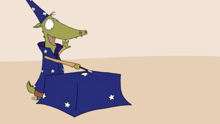 Ein Krokodil in einem mit Sternen verzierten Zaubererhut und Umhang steht hinter einem mit Sternen bedeckten Tisch und zeigt mit einem Zauberstab darauf.